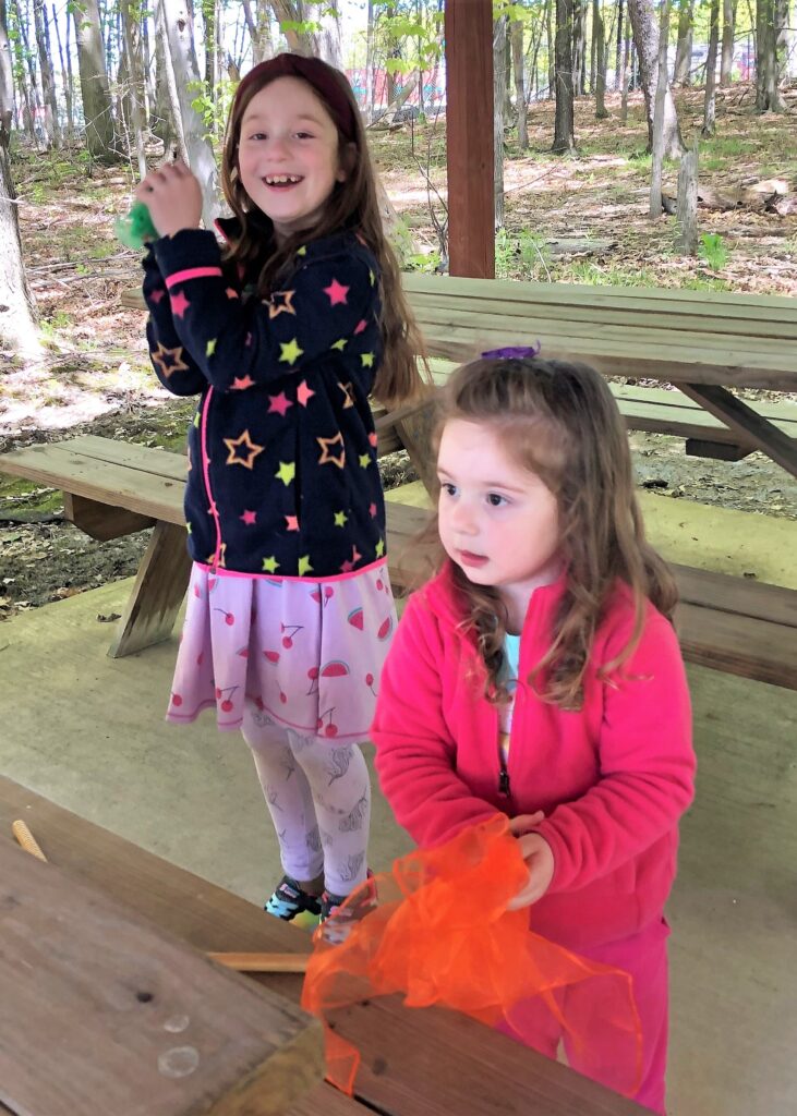 Sisters dancing with scarves as props